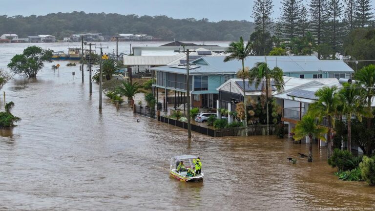 Heavy rains flood southeastern Australia, claiming four lives and cutting off thousands from the outside world amid rising river levels.